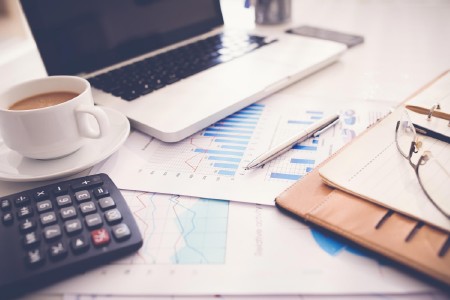 a calculator and a pen on a desk